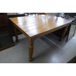 A stained pine kitchen table