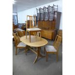 A Nathan teak extending dining table and four chairs