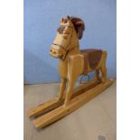 A hand carved pine rocking horse
