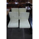 A set of four chrome and cream leather chairs