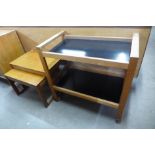 A teak trolley and a nest of two tables