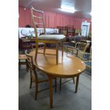 A teak extending dining table and four chairs