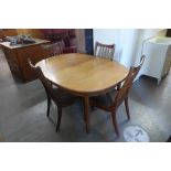 A teak extending dining table and four chairs