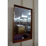 A teak framed mirror