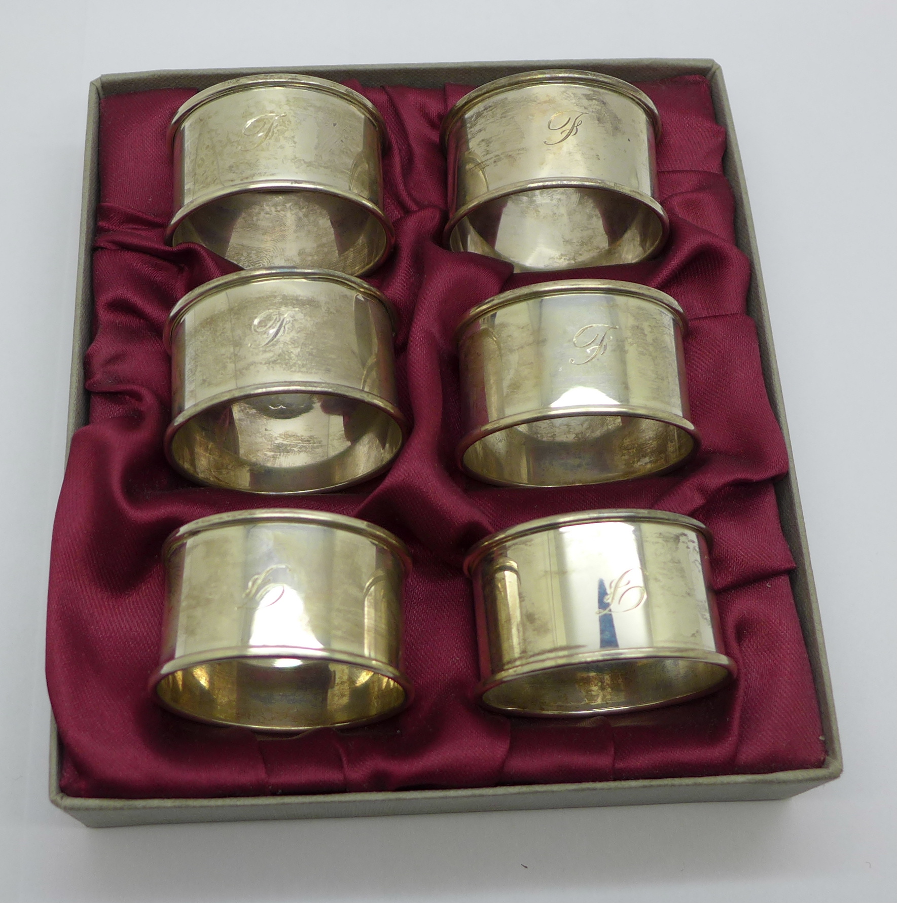 A boxed set of six silver napkin rings, 68g