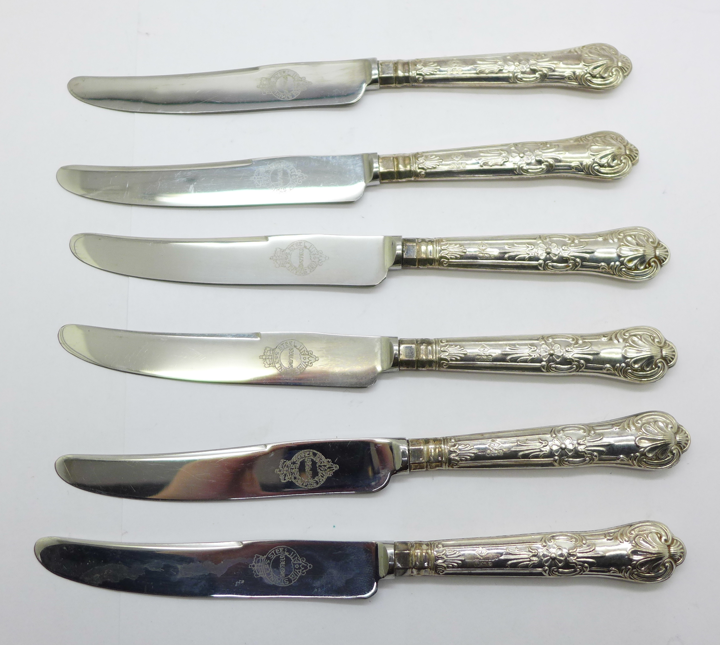 Six silver handled knives