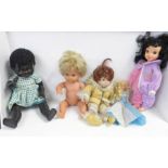 A 1950's Pedigree black doll and four other dolls