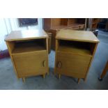 A pair of teak bedside cabinets