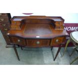 An inlaid mahogany and leather topped writing desk