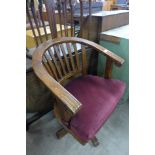 A mahogany swivel office armchair