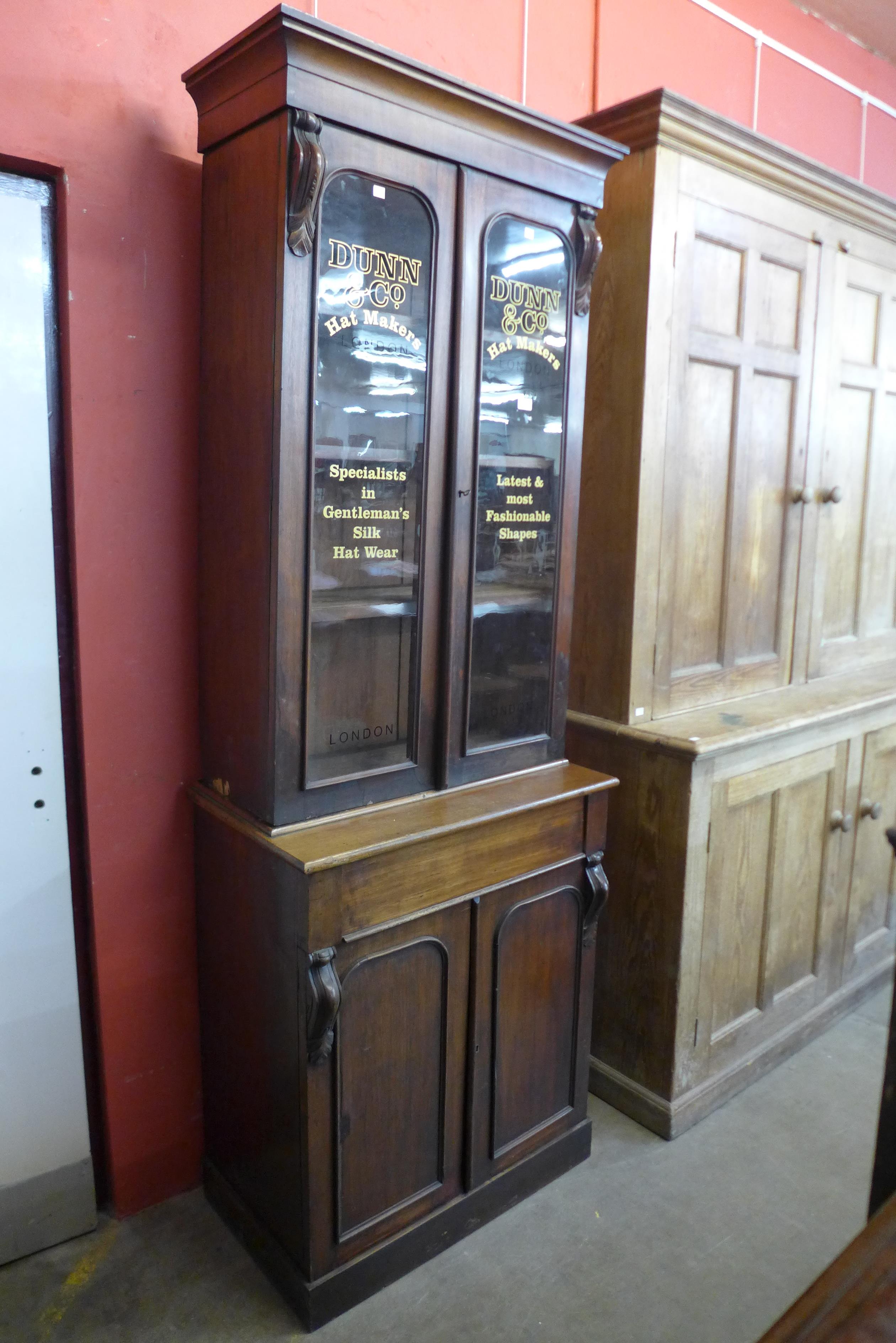 A Victorian mahogany bookcase, bearing later Dunn & Co. Hat Makers, London inscription to doors