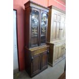 A Victorian mahogany bookcase, bearing later Dunn & Co. Hat Makers, London inscription to doors