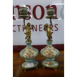 A pair of French style turquoise porcelain and gilt metal figural cherub candlesticks
