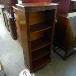 An inlaid mahogany bow front open bookcase