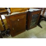 Two George III oak and mahogany wall hanging corner cupboards