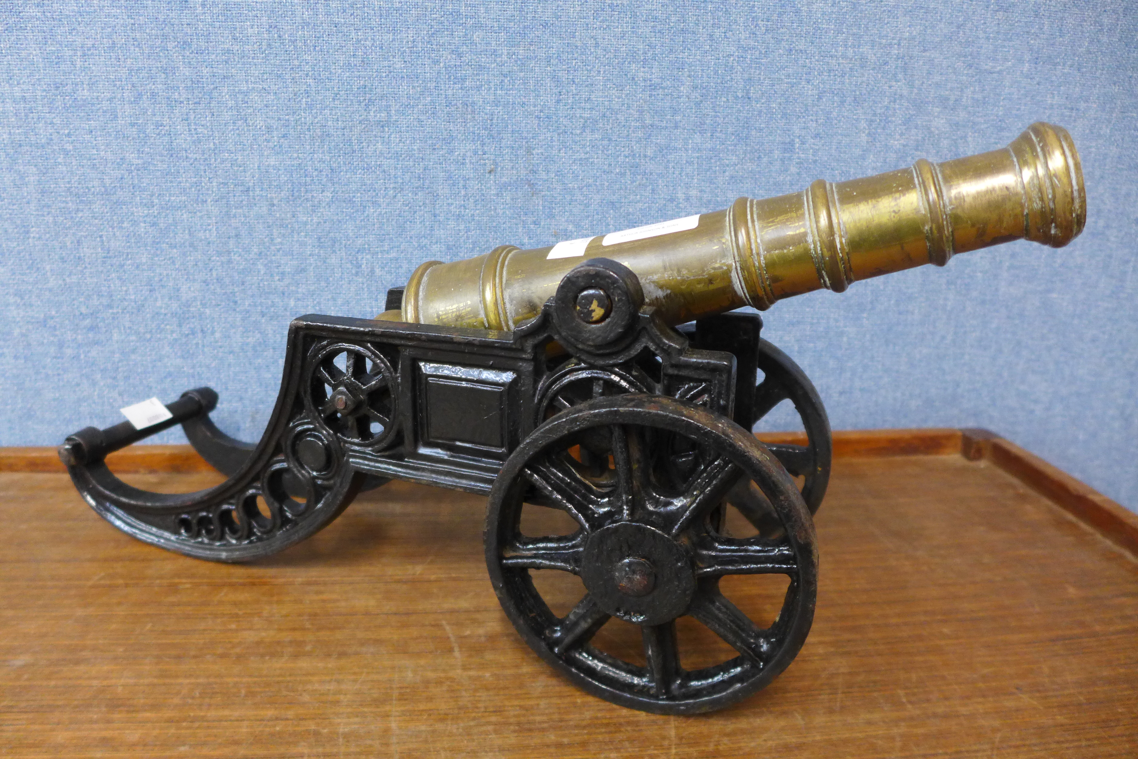 A cast iron and brass miniature cannon