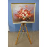 An artist's easel and a still life of flowers, oil on canvas, framed