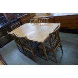 A teak extending dining table and six chairs