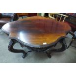 A Victorian rosewood serpentine centre table