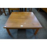 A teak square coffee table