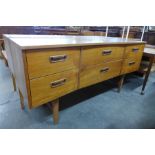 A teak concave sideboard