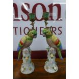 A pair of French style porcelain figural parrot candlesticks