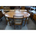 A teak extending dining table and four chairs