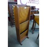 An Art Deco walnut newspaper stand