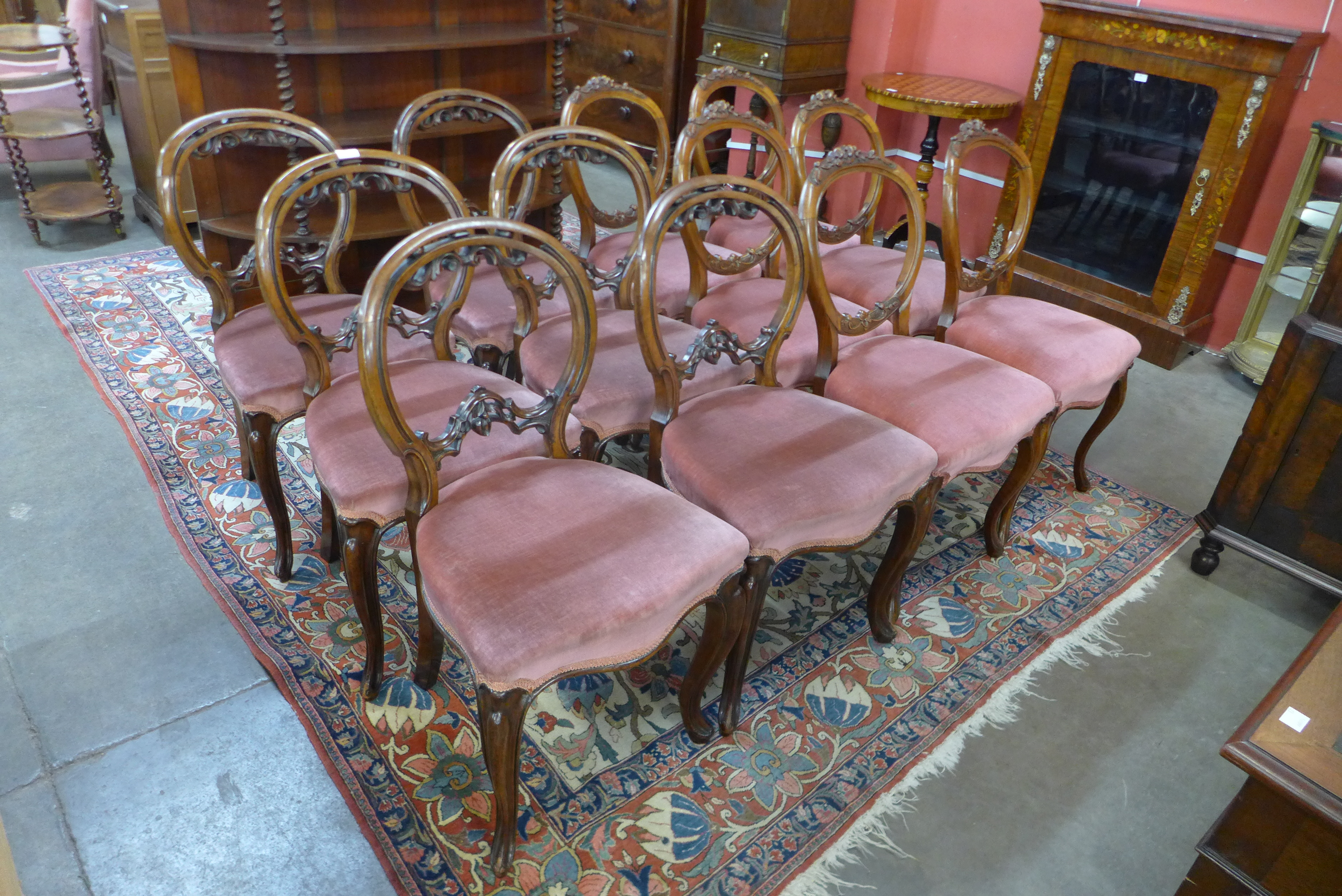 A Harlequin set of twelve Victorian walnut balloon back dining chairs (6+6)