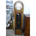 A 1930's oak triple weight longcase clock