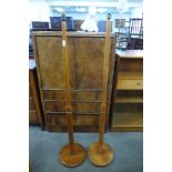 A pair of teak standard lamps