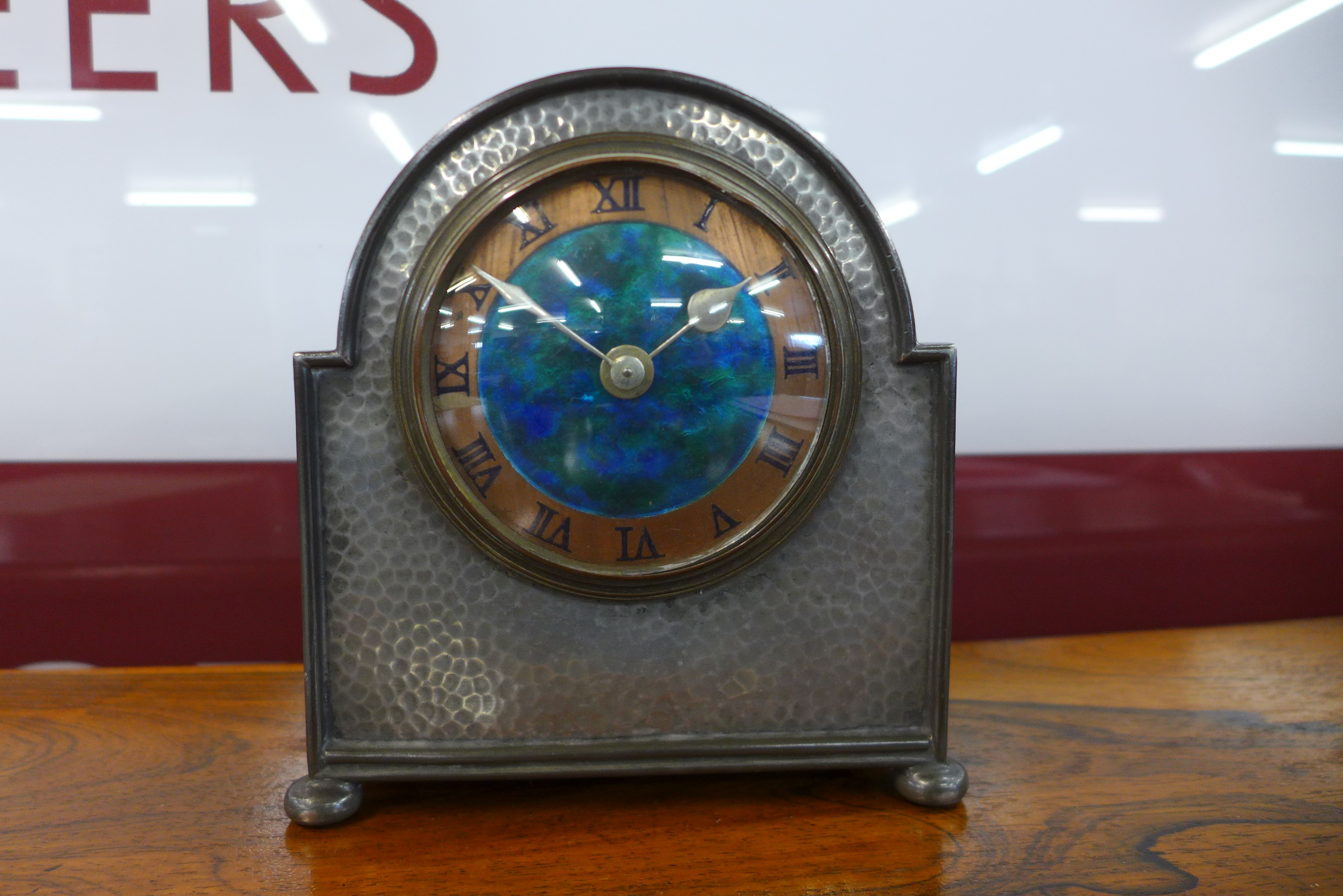 A Liberty & Co. Arts and Crafts Tudric Pewter mantel timepiece, with turquoise enamelled dial, the