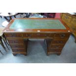 A yew wood and green leather topped pedestal desk