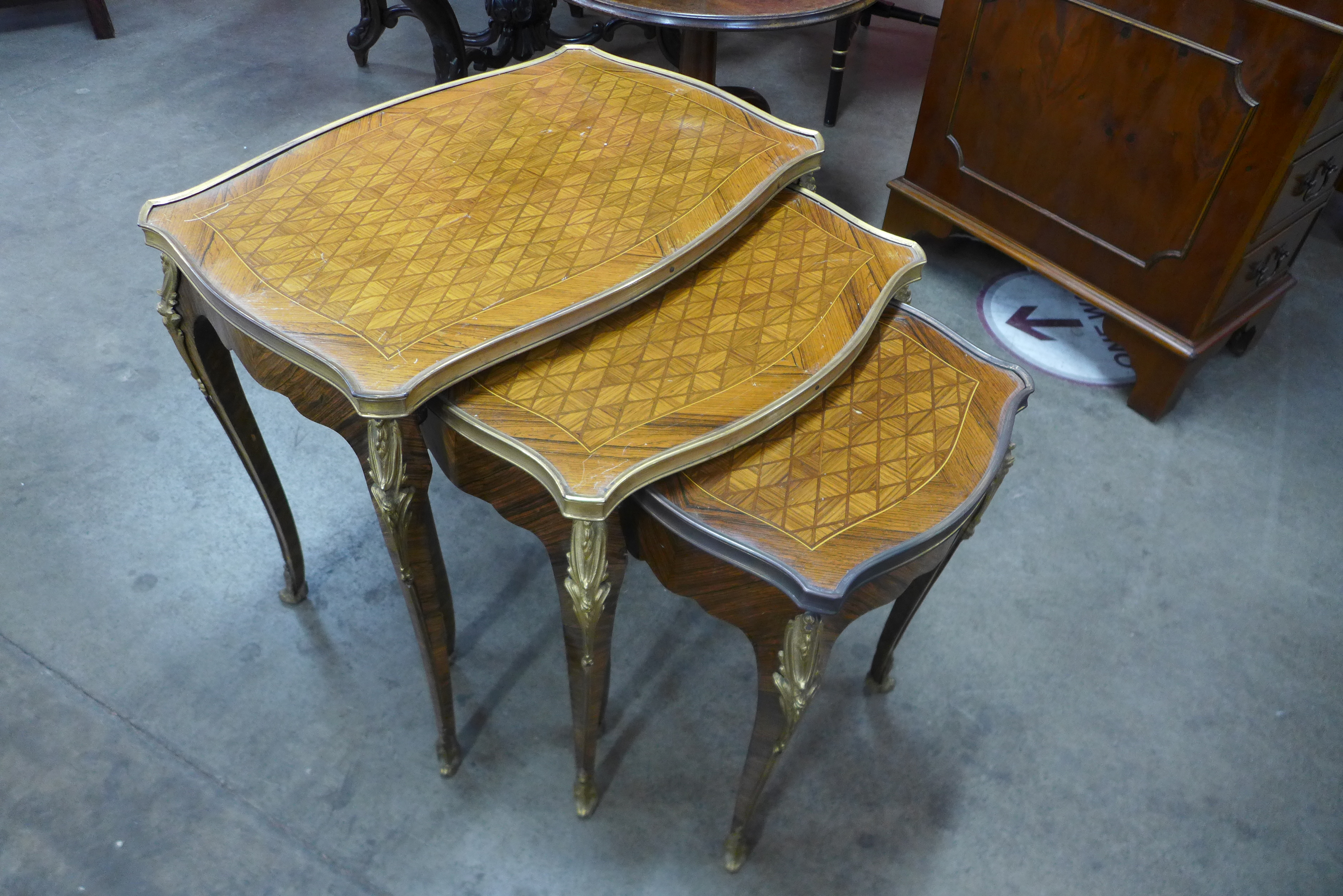 A French Louis XV style parquetry inlaid rosewood and ormolu mounted nest of tables