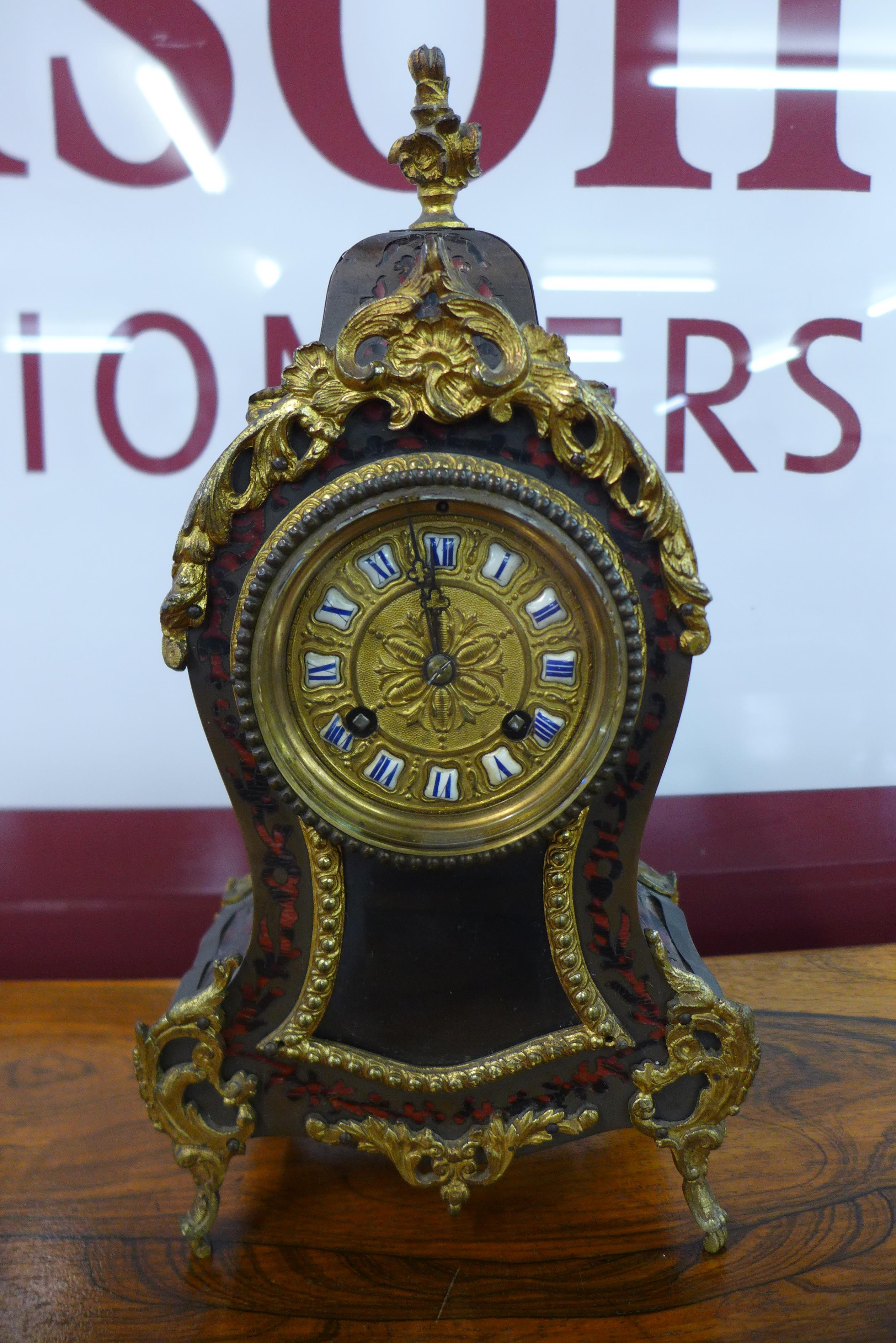 A 19th Century French Boulle style mantel timepiece, stamped Marti & Cie. (lacking pendulum)