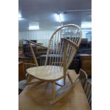 An Ercol Blonde elm and beech Windsor rocking chair