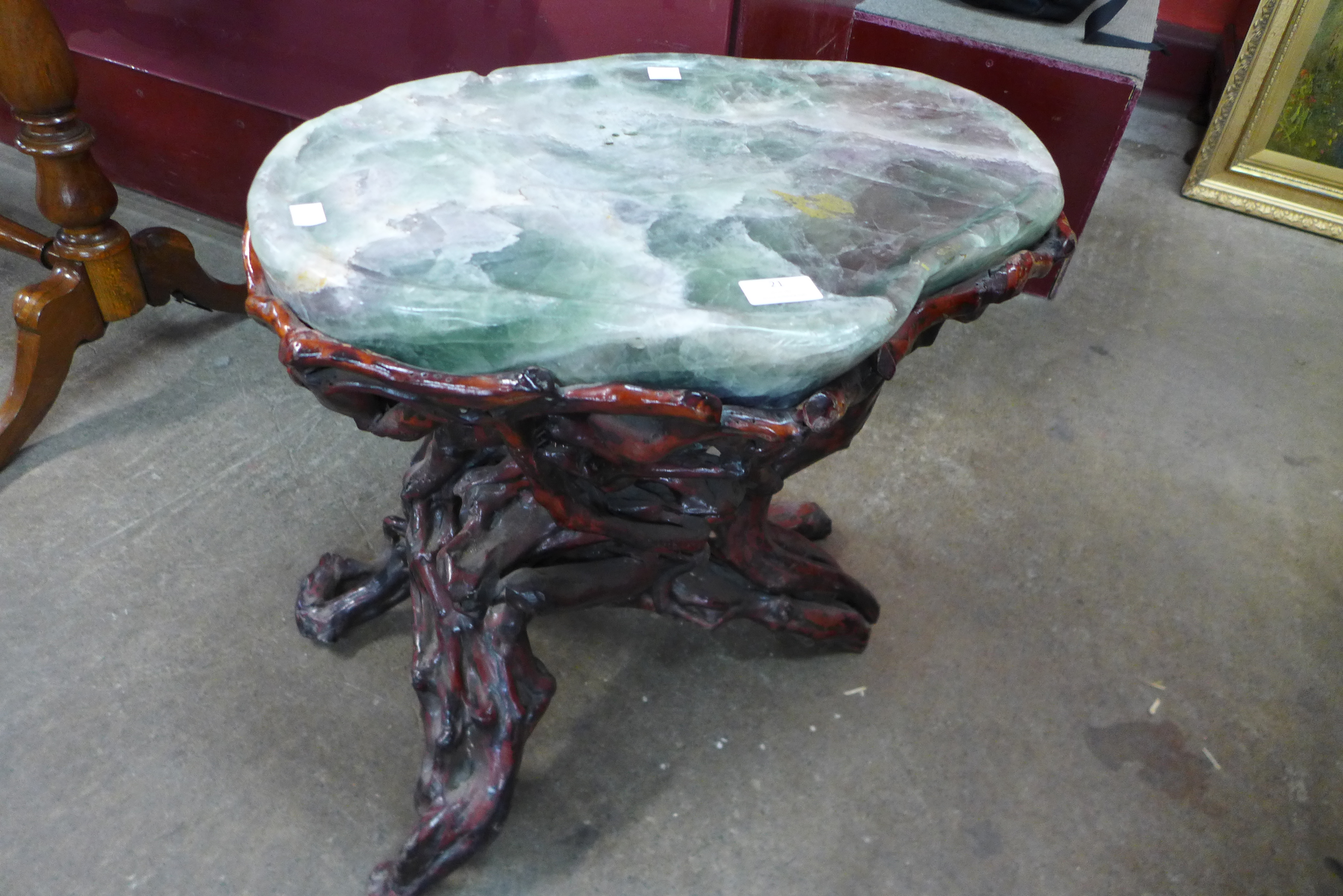 A Chinese green hardstone occasional table, on naturalistic root wood stand