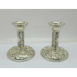 A pair of embossed silver candlesticks, Birmingham marks, also marked Filled, 9.5cm