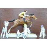 A Beswick figure of a girl on jumping horse, both front legs a/f, 27.5cm and three stylised animals