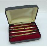 A cased set of four silver bridge pencils