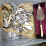 A large collection of silver plated cutlery, a pair of berry spoons, cased, and a plated