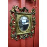 A small Italian Florentine carved giltwood mirror