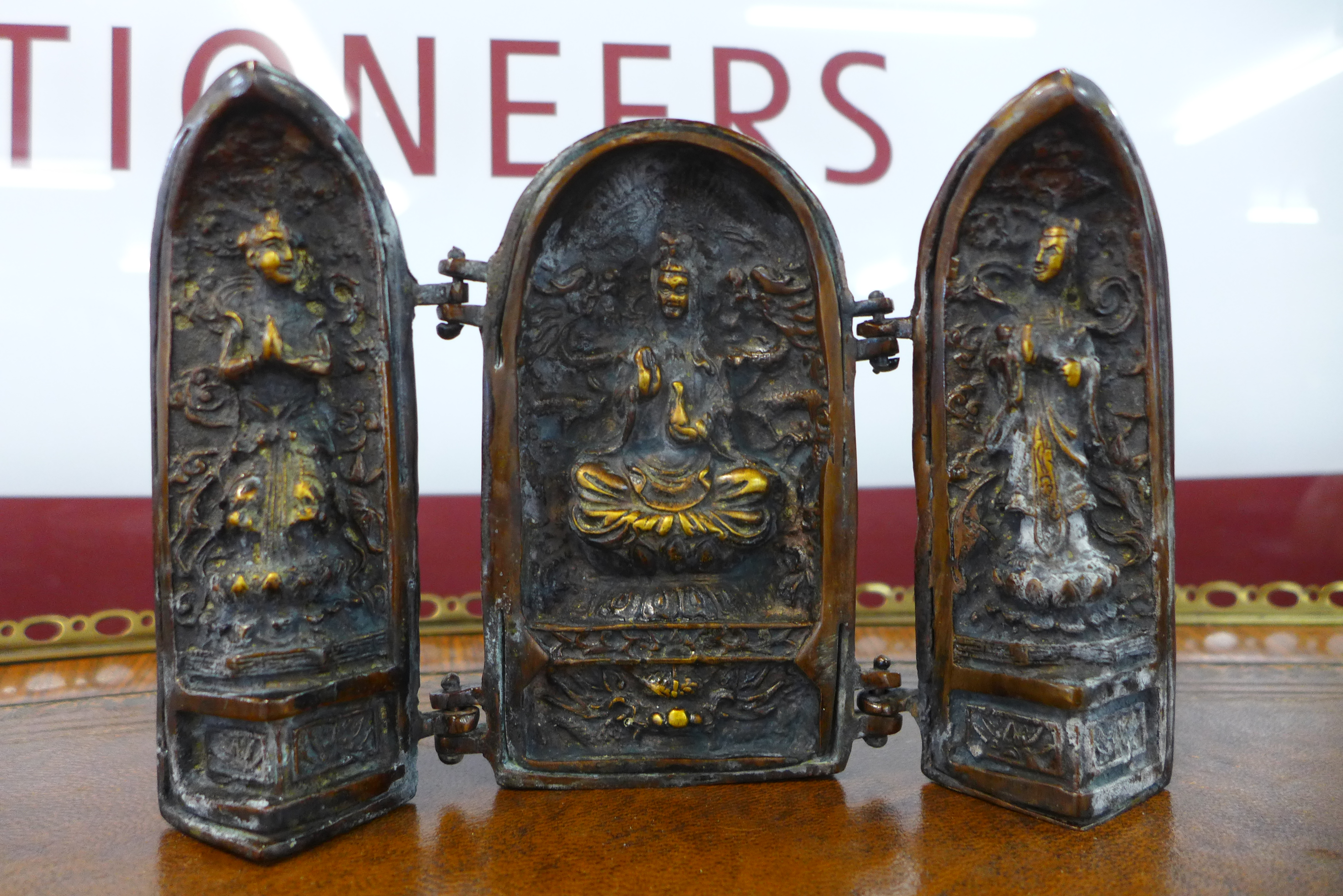 A small oriental bronze triptych