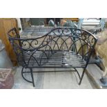 A painted wrought iron garden conversation seat