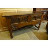 A 17th Century style carved oak two drawer dresser