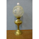 A Victorian brass oil lamp with etched glass shade