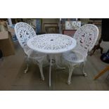 A circular cast aluminium garden table and two chairs