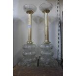 A pair of glass and metal candlesticks