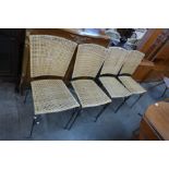 A set of four metal and wicker chairs