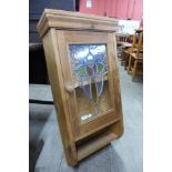 A pine and stained glass wall hanging cabinet